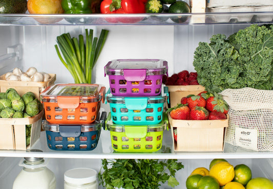 Colorful food storage containers and fresh produce organized inside a refrigerator. Explore fridges with flexible storage and energy efficiency.