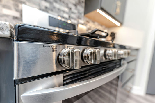 Close-up of a stainless steel gas range with precision burner controls, perfect for high-performance cooking and modern kitchen design.