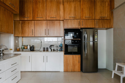 Modern Canadian kitchen with stainless steel LG refrigerator, built-in oven, and wooden cabinetry, showcasing efficient use of space and home appliance integration.